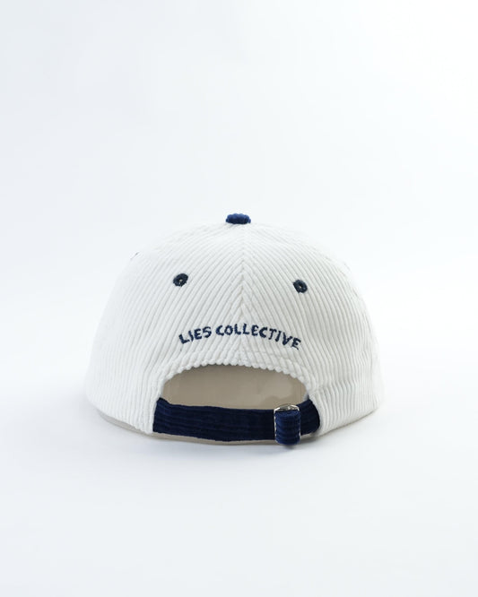White pinstripe baseball cap with navy brim, buckle strap, and 'LIES COLLECTIVE' back