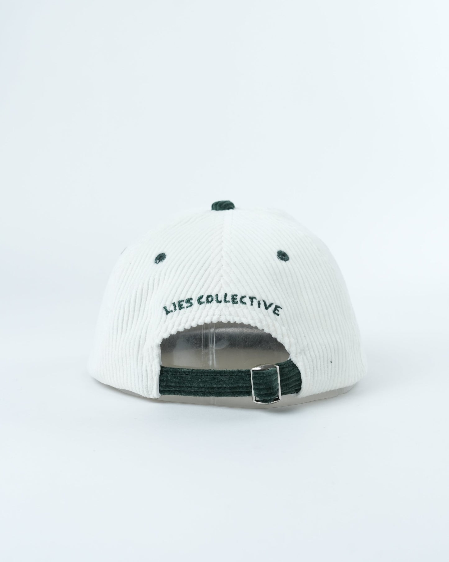 White ribbed cap with dark green strap and 'Lies Collective' back logo
