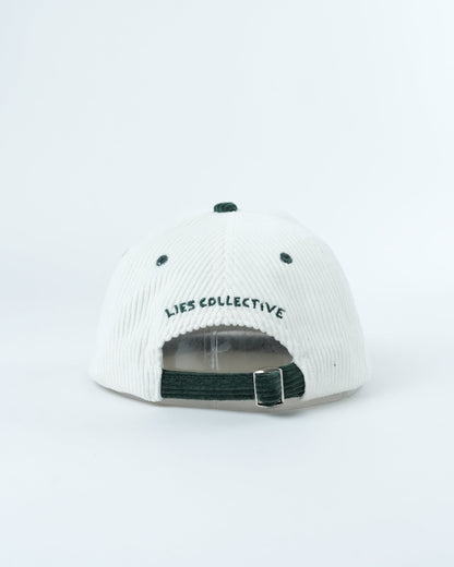 White ribbed cap with dark green strap and 'Lies Collective' back logo