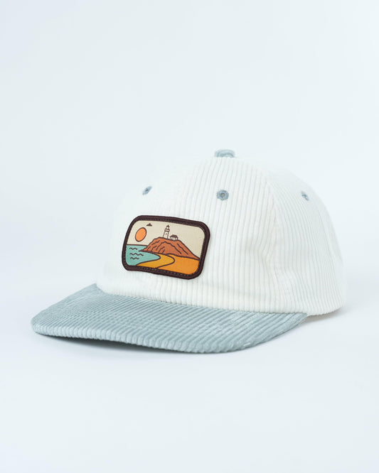 White corduroy baseball cap with light blue brim and beach landscape front patch
