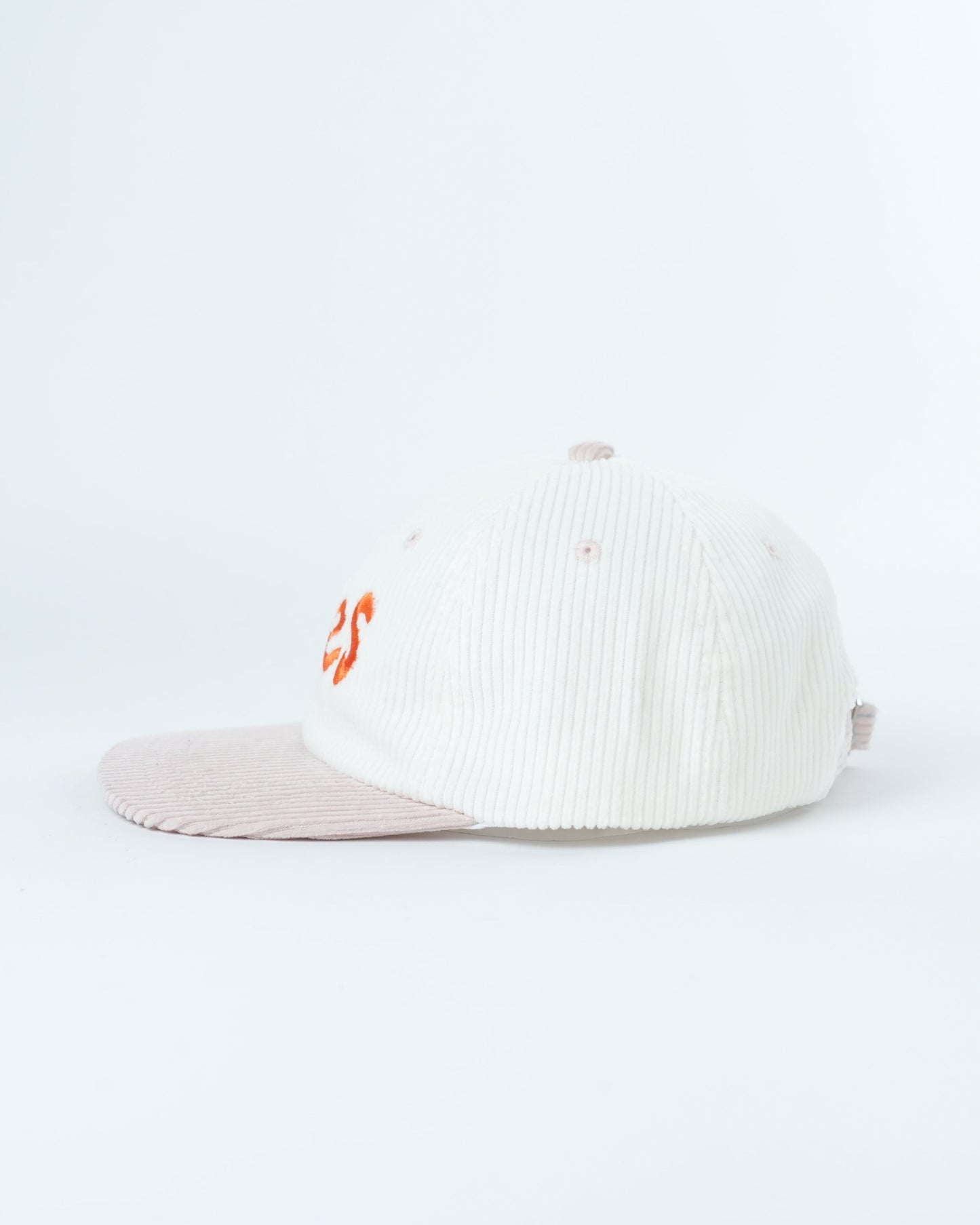 White ribbed knit cap with small orange side logo and light pink brim