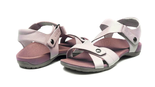 Nude orthotic sandals with two wide straps, metal buckles, and cushioned gray outsole
