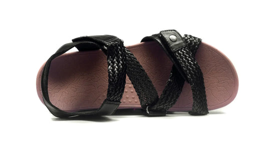 Black orthotic sandals with crisscross braided straps and open-toe slide fit