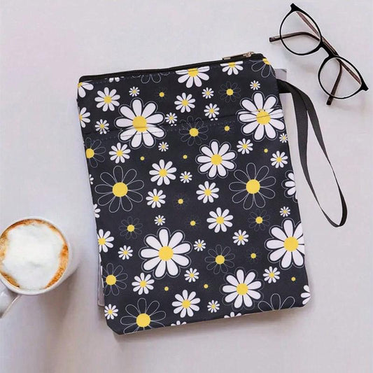Black book sleeve with daisy pattern, zip closure, and carry strap looped at top
