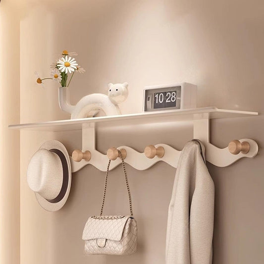 White wall-mounted coat rack with floating shelf and six wooden coat hooks