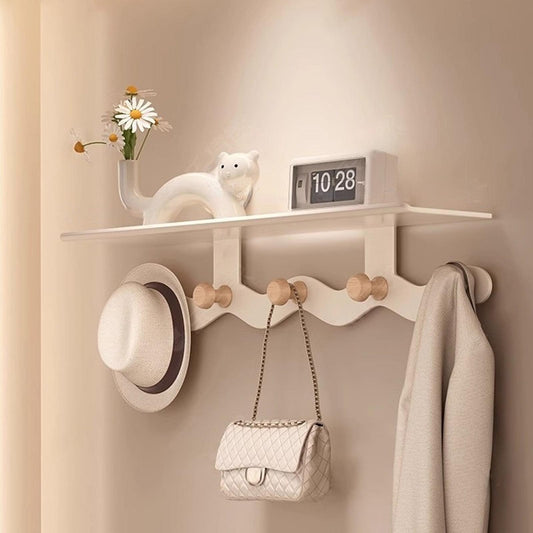 Wall-mounted coat rack with shelf, white rail and light wood hooks
