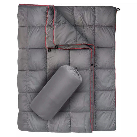 Gray quilted down camping blanket with red-trim edges and rolled storage pouch