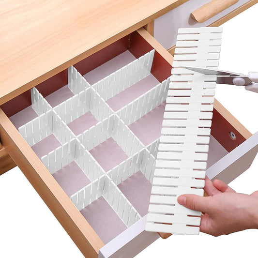 Adjustable white drawer divider organizer with interlocking grid panels, being placed