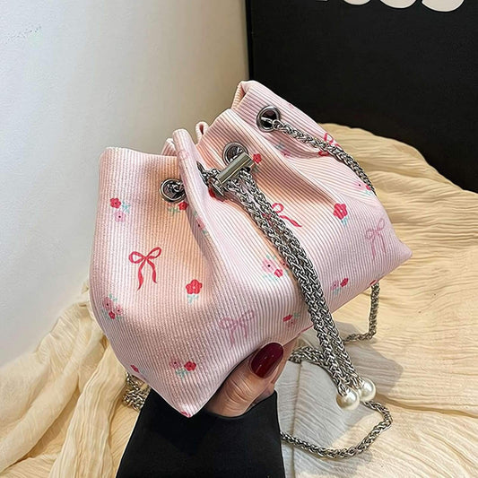 Pink striped mini bucket bag with bow print, silver chain strap and bead tassels