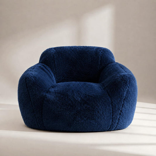 Navy blue plush lounge chair with rounded armrests and thick cushioned seat.