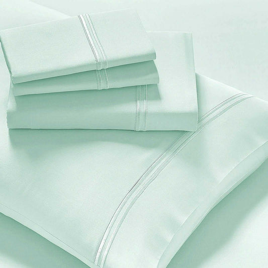 Queen sheet set in light mint with embroidered border and stitched edges
