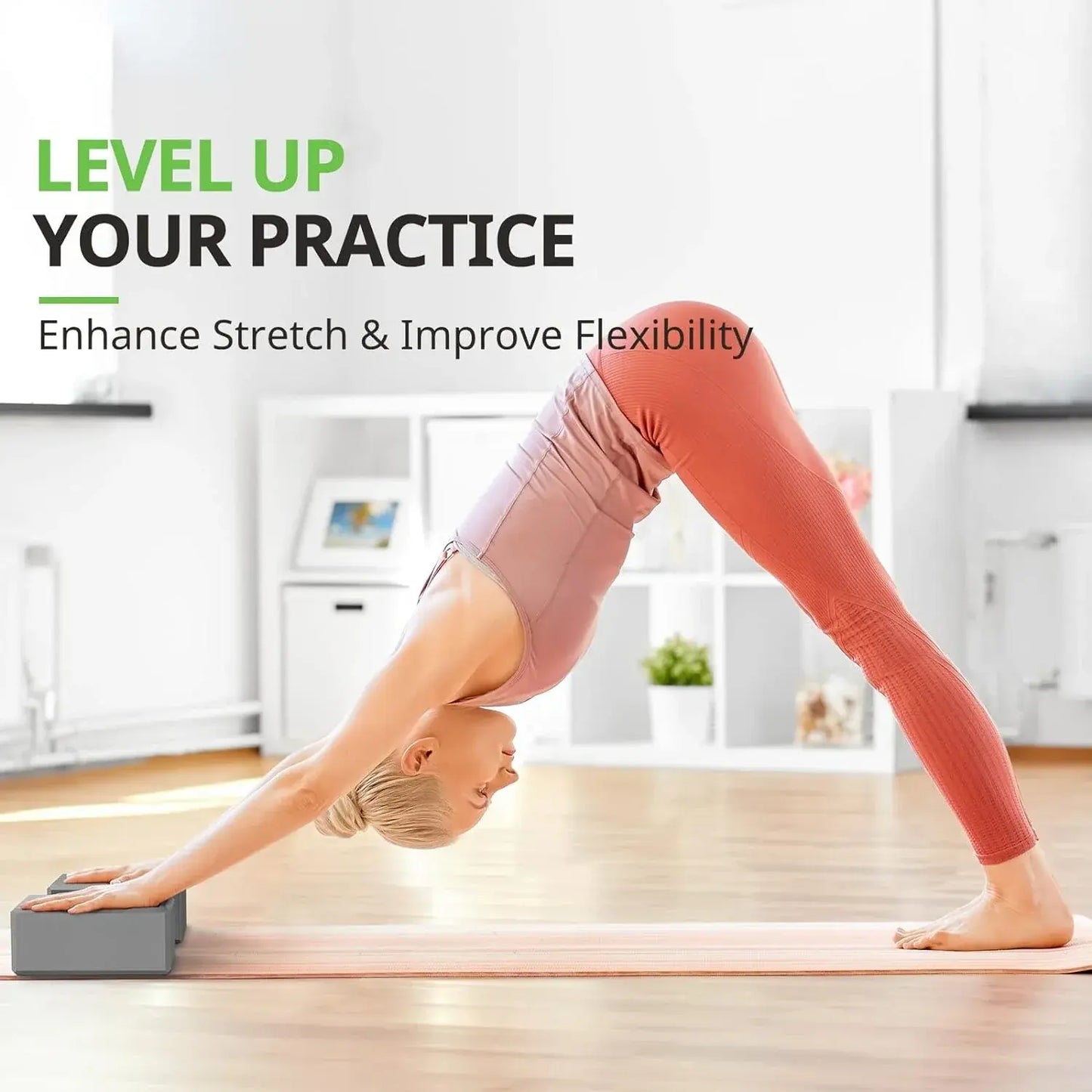 Grey foam yoga block under hands for a stretch and balance pose