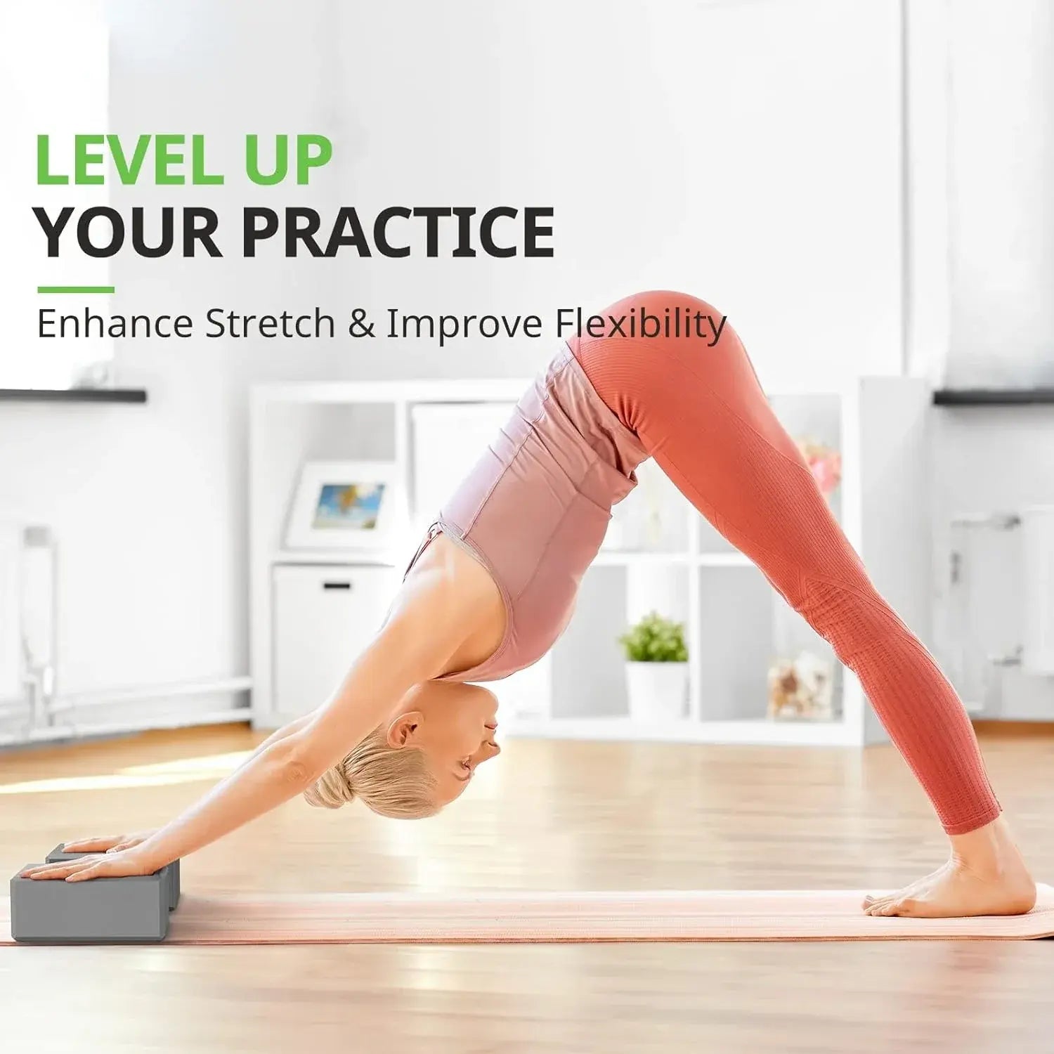 Grey foam yoga block under hands for a stretch and balance pose