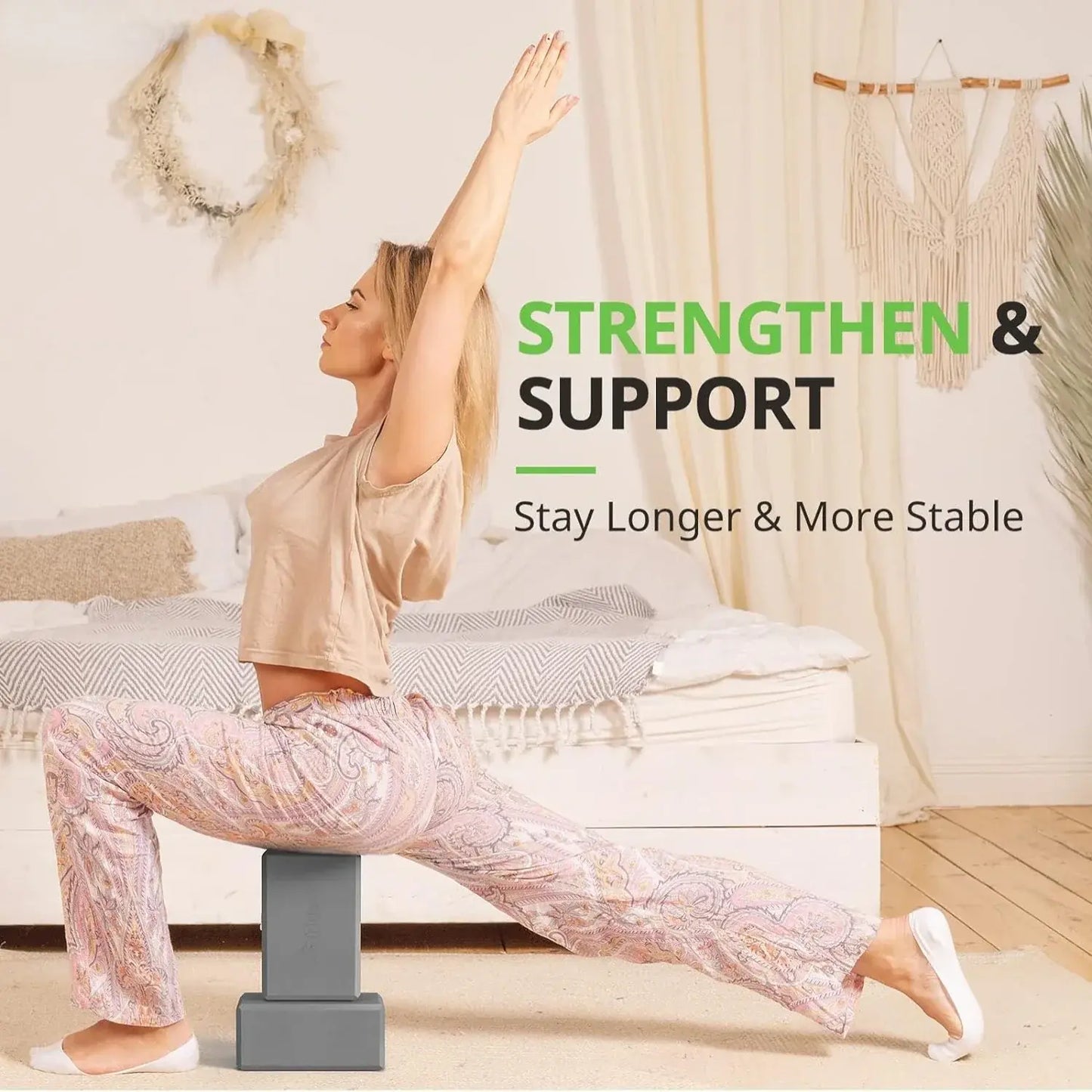 Grey foam yoga blocks supporting a seated yoga pose, one block on the floor