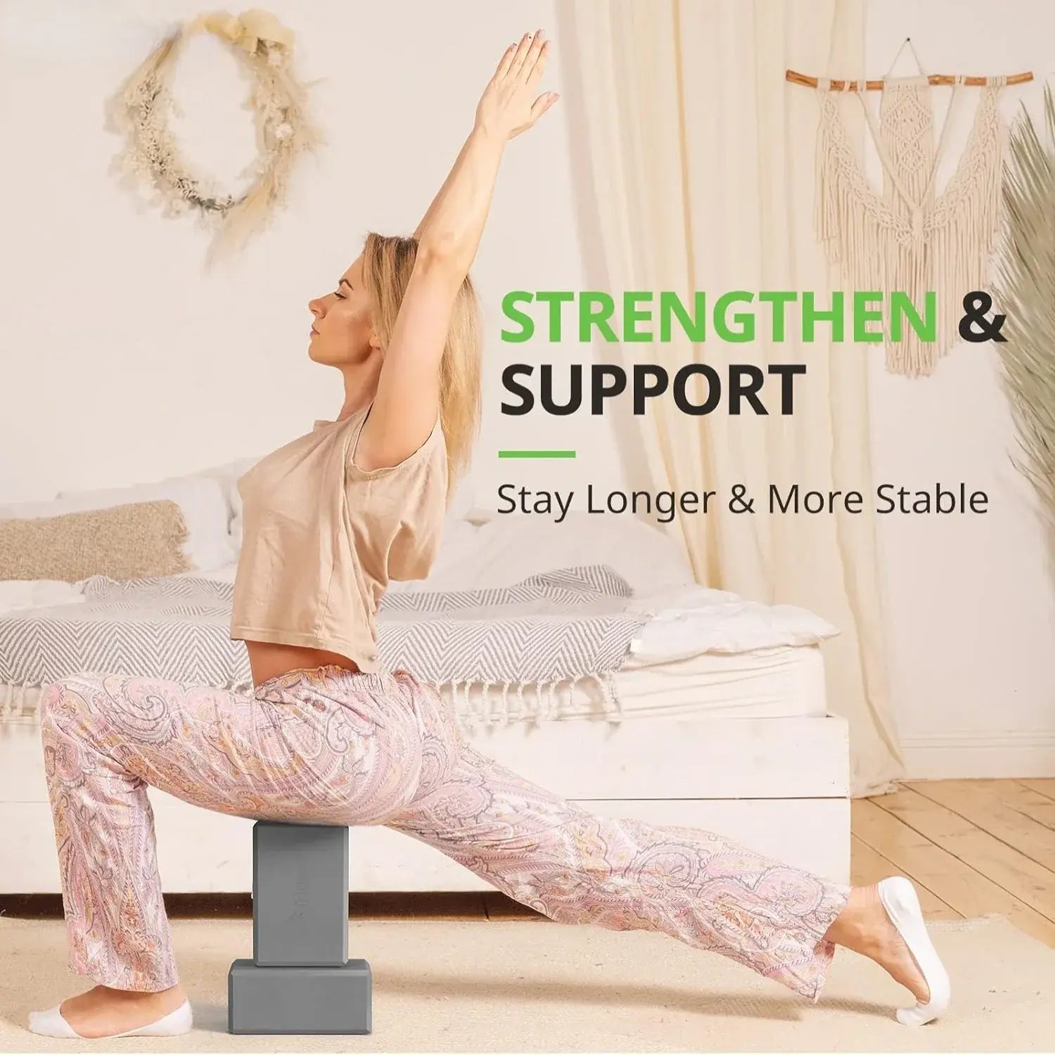 Grey foam yoga blocks supporting a seated yoga pose, one block on the floor