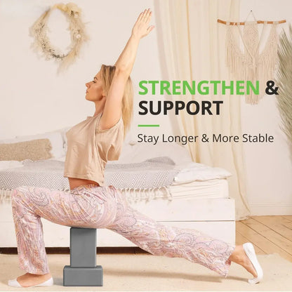 Grey foam yoga blocks supporting a seated yoga pose, one block on the floor