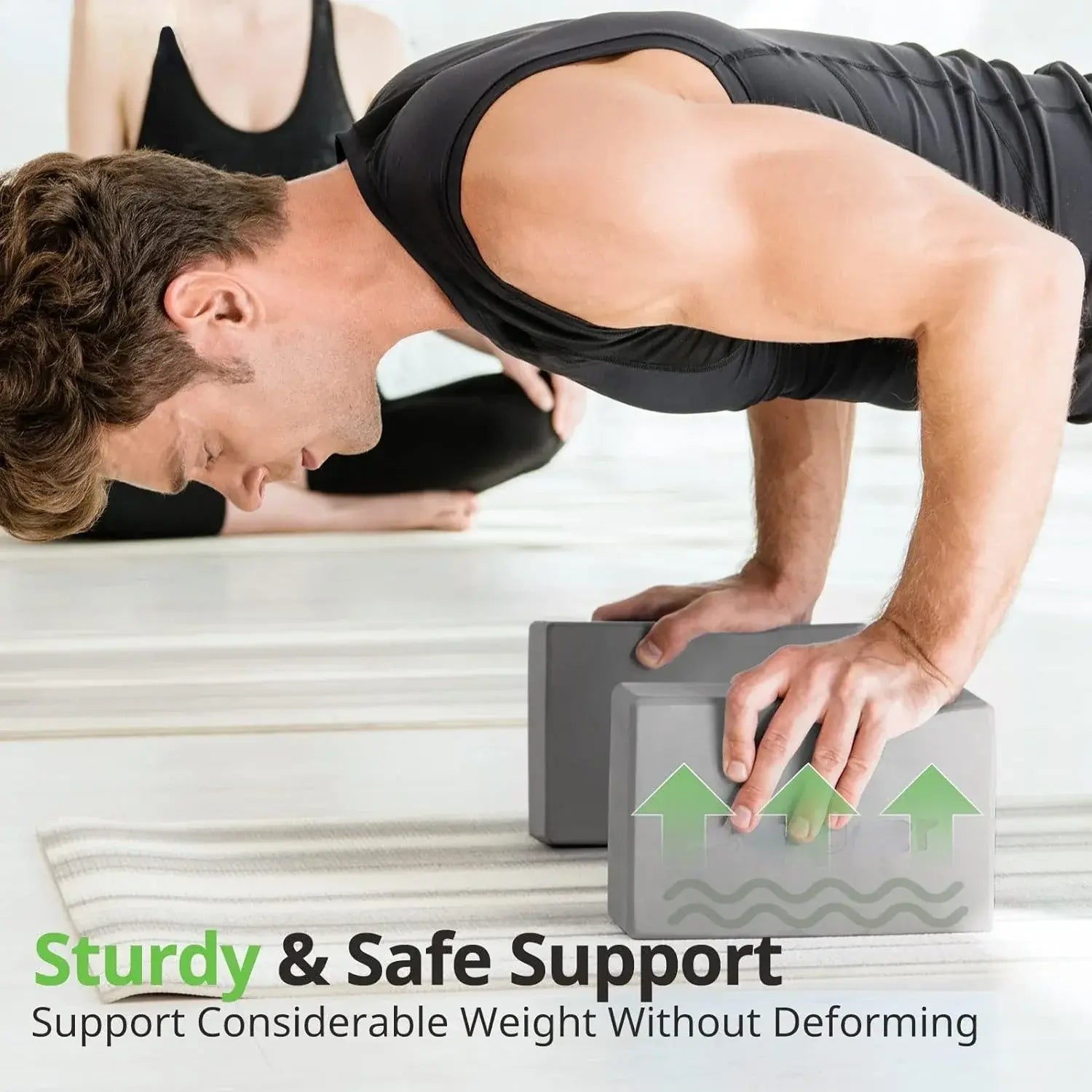 Grey foam yoga block set used for hand support in a plank pose