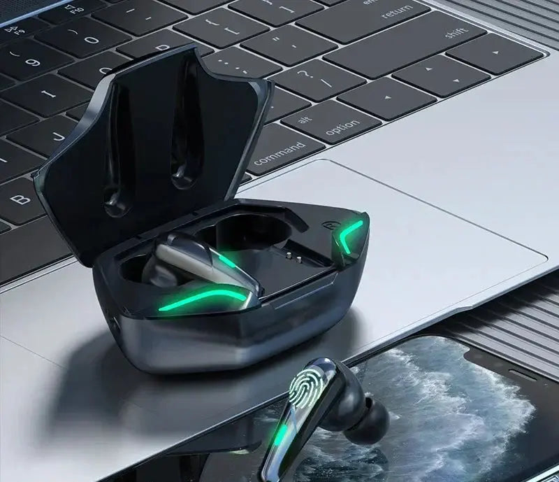 Black wireless earbuds with green LED charging in open charging case