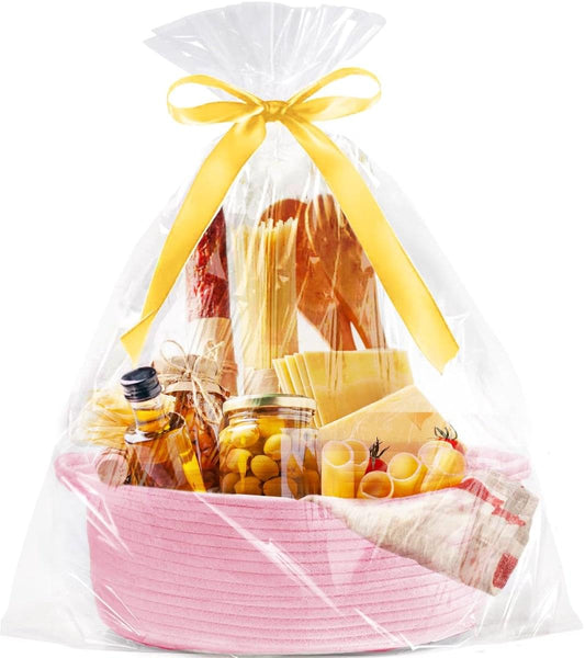 Pink woven rope storage basket in clear gift bag with yellow ribbon, filled with treats