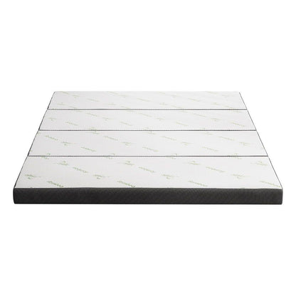 Folded-out queen mattress with white top surface and dark gray side border