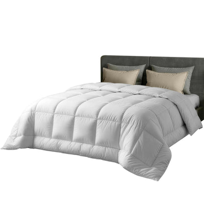 White quilt with box baffle stitching, spread over a bed in a side view