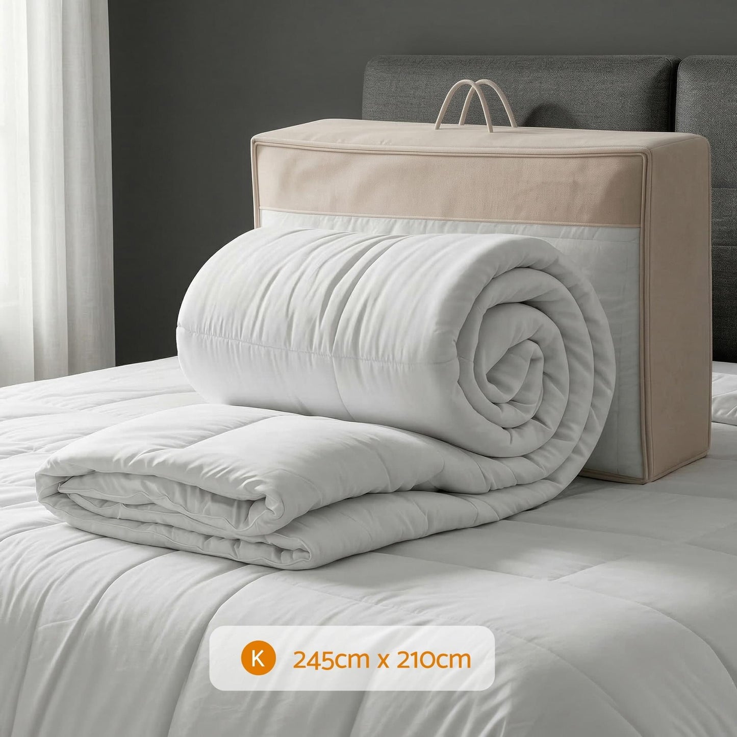 Rolled white wool quilt with thick box-baffle filling, stacked on a bed