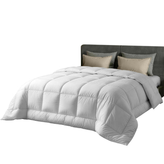 White baffle box quilt with thick quilted channels, draped over bed with matching pillows