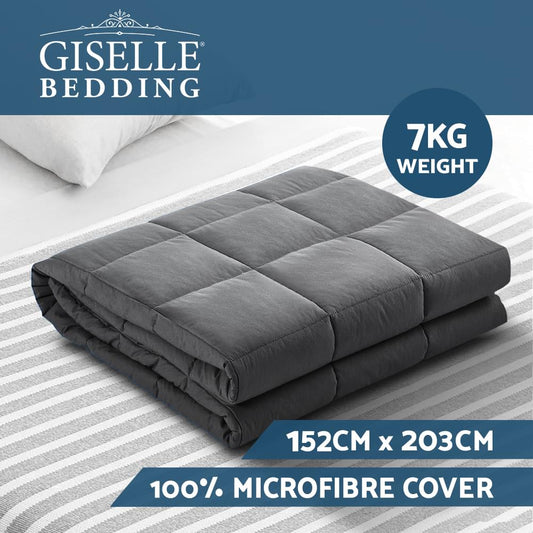 Dark gray quilted weighted blanket folded on a bed, with channel stitching