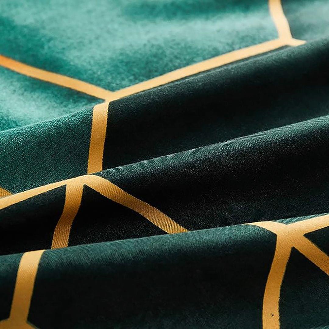 Quilt fabric close-up with dark green base, teal overlay, yellow geometric stripes