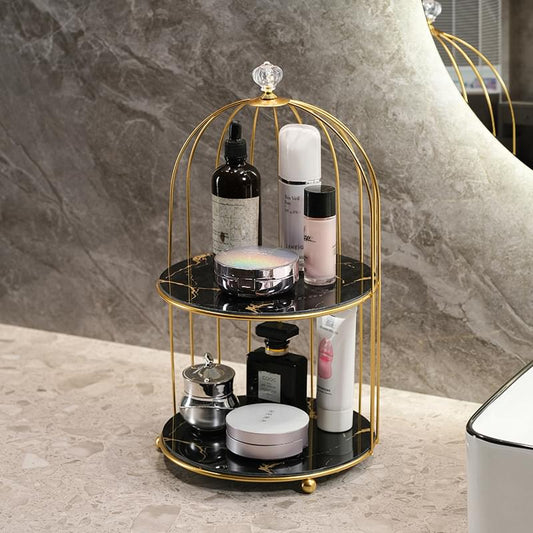 Two-tier birdcage cosmetic organizer with gold frame and black-and-white skincare bottles
