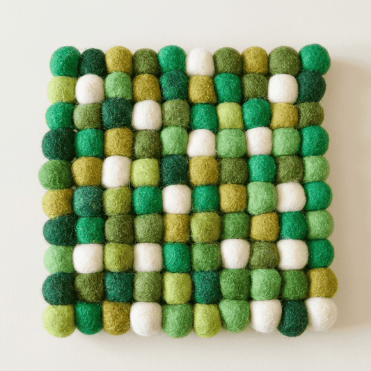 Square wool felt heat mat with green, white, and gold felt ball pattern