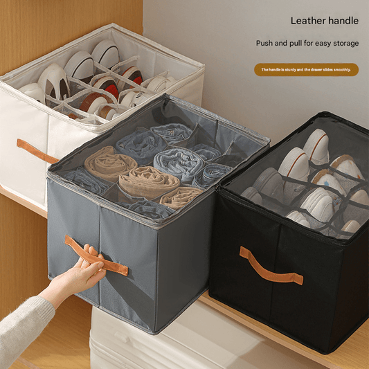 Foldable grey and black shoe storage boxes with orange handles; open divided compartments