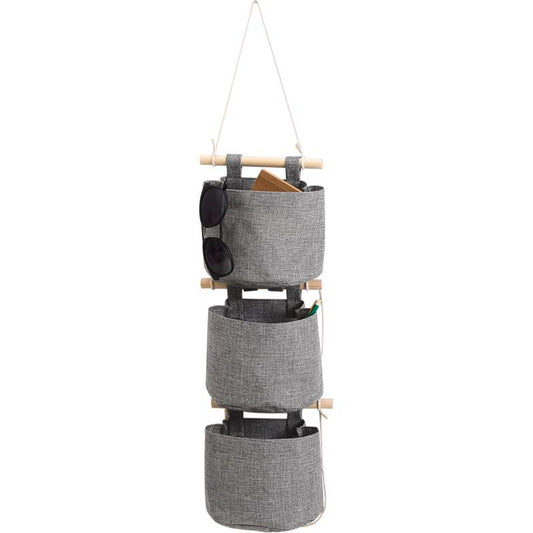 Gray hanging storage bag with three fabric pockets and loop straps