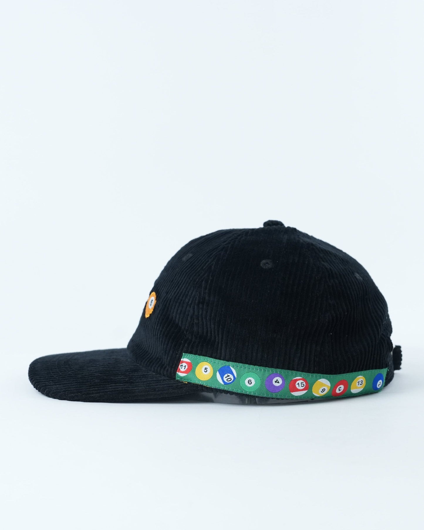 Black corduroy baseball cap with pool-ball patch and multicolor circular band on brim