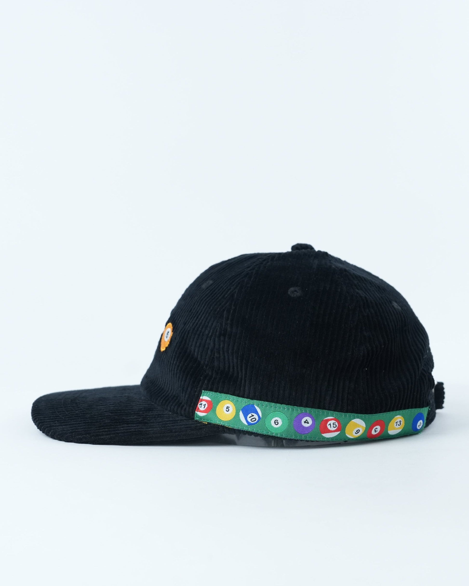 Black corduroy baseball cap with pool-ball patch and multicolor circular band on brim