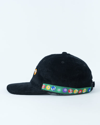 Black corduroy baseball cap with pool-ball patch and multicolor circular band on brim