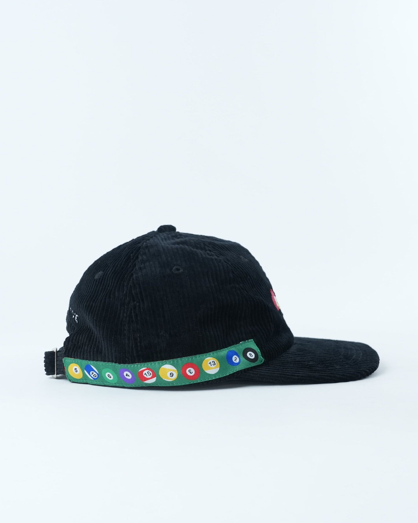Black corduroy baseball cap with multicolor pool-ball trim along side brim