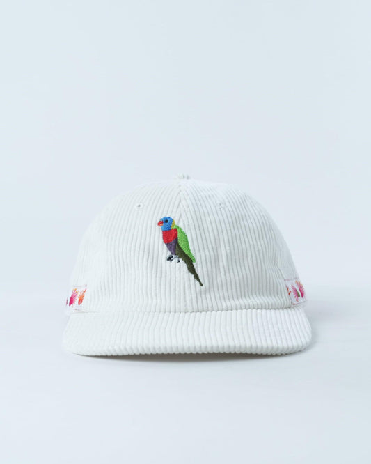 White ribbed cap with embroidered rainbow lorikeet on front