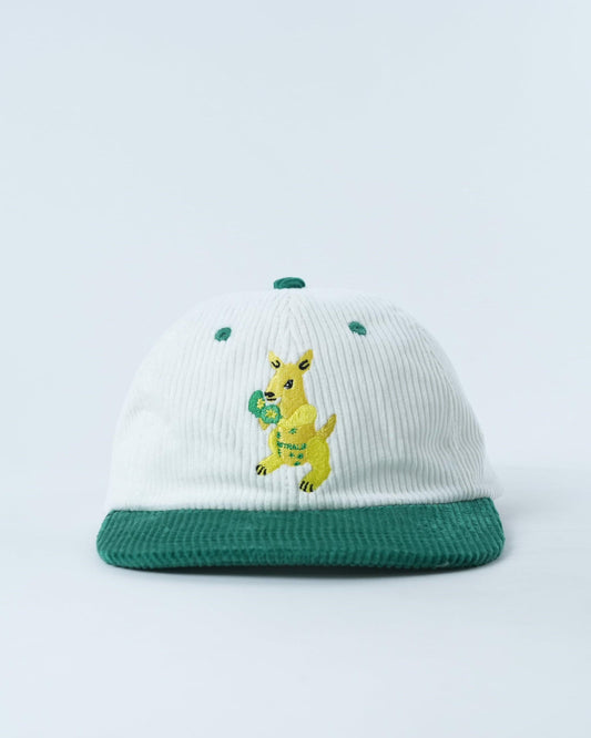 White ribbed kids cap with green brim and yellow bunny-style embroidery