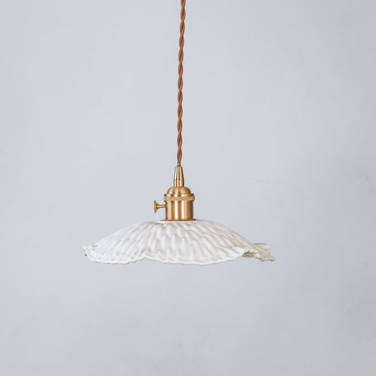 Ceramic textured pendant light with white ribbed shade and brass-toned metal canopy