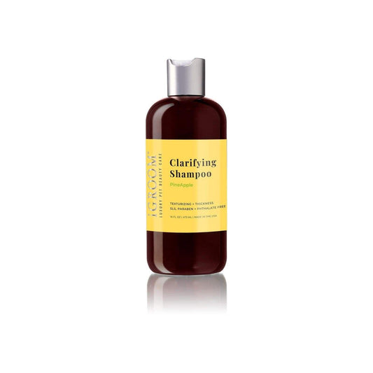 iGROOM clarifying shampoo bottle with silver pump, amber glass, gold label