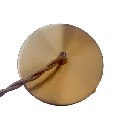 Antique brass ceiling canopy with braided cord connection for pendant light.