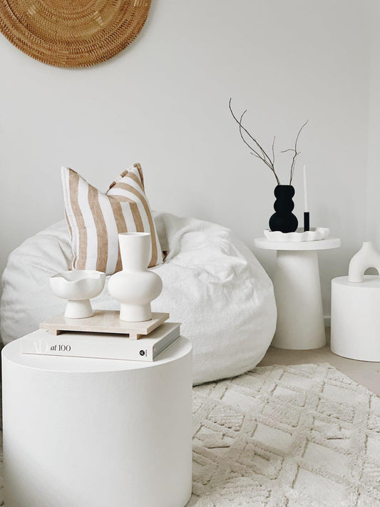 White boucle fur bean bag, rounded shape with smooth fabric surface.