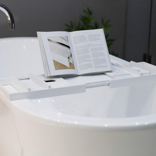 White bamboo bath caddy with open book holder and side accessory tray