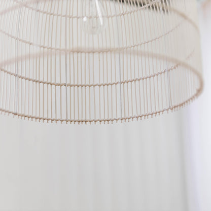 Close-up of whitewash rattan cane pendant shade with curved ribs and slatted lattice