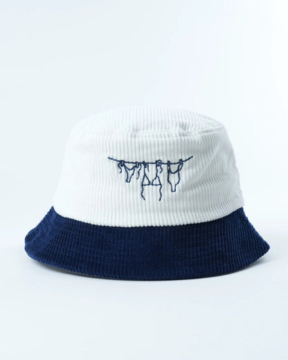 Two-tone bucket hat with navy brim and white crown, embroidered navy hanging letters