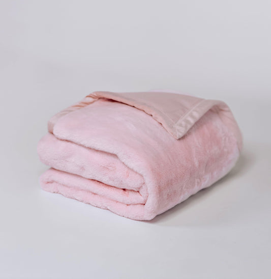 Pink plush fur throw blanket, folded with a soft textured pile
