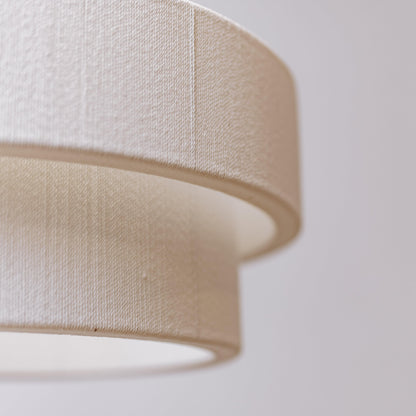 Textured white fabric drum shade for a double-tier rope chandelier
