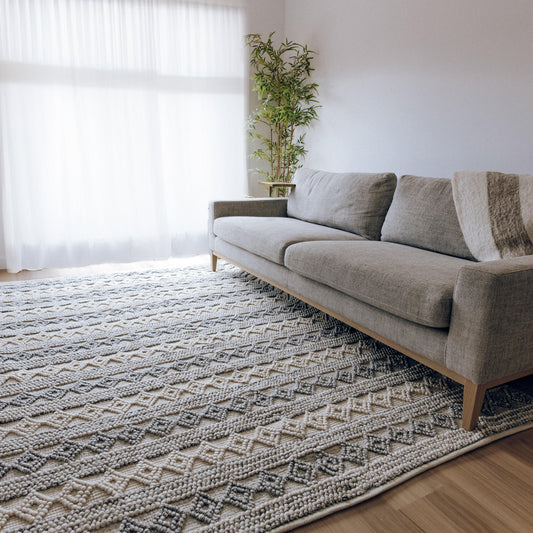 Handwoven floor rug with looped pile, blue-gray and natural geometric pattern