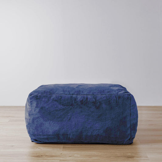 Navy blue upholstered ottoman with rounded corners and plush texture
